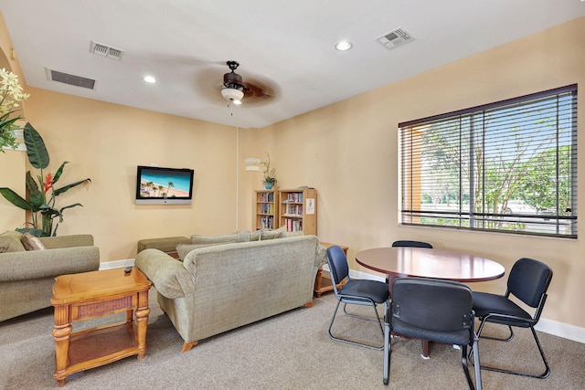 living room with ceiling fan and carpet floors