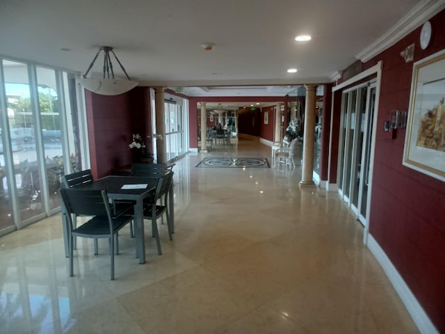 dining space with decorative columns and ornamental molding