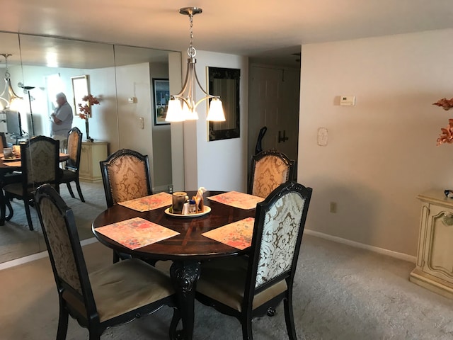 dining space with an inviting chandelier