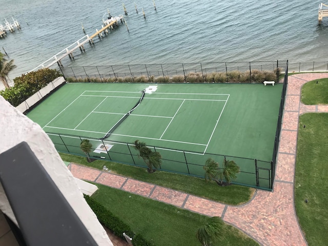 view of tennis court with a water view