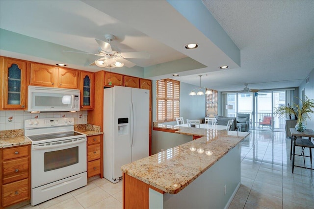 kitchen with a center island, white appliances, ceiling fan, decorative backsplash, and light tile patterned floors