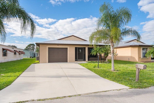 view of front of house featuring a garage and a front lawn