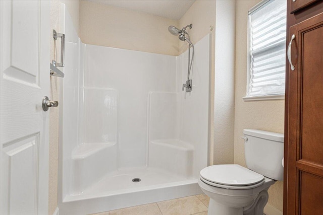 bathroom featuring tile patterned flooring, a healthy amount of sunlight, and a shower