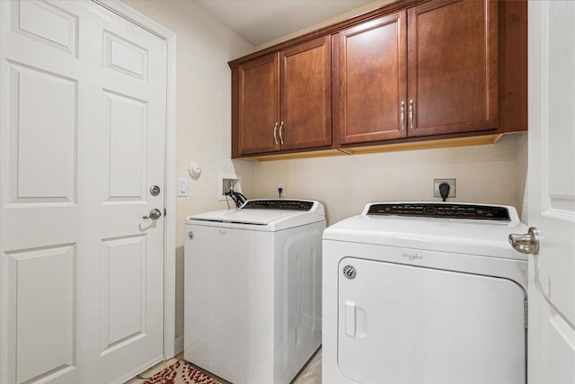 washroom featuring cabinets and independent washer and dryer