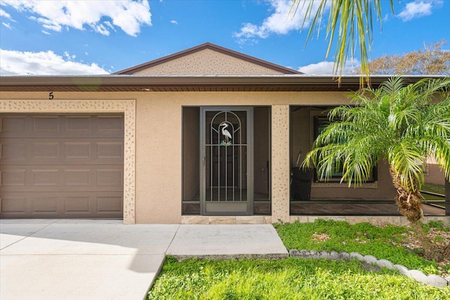 doorway to property with a garage