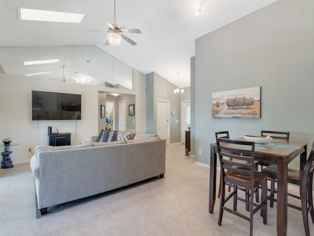 living room featuring ceiling fan, high vaulted ceiling, and light tile patterned floors