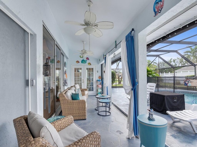 sunroom / solarium featuring french doors, ceiling fan, lofted ceiling, and a swimming pool