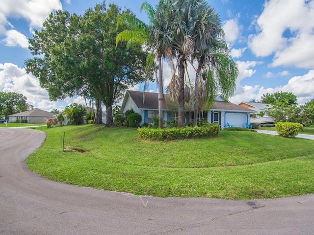 single story home with a front lawn and a garage