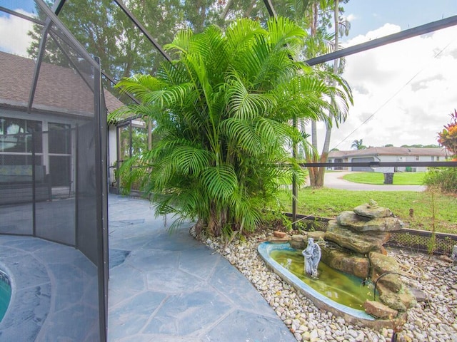 view of patio / terrace featuring a lanai