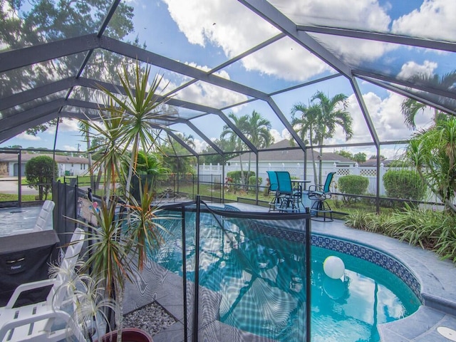 view of swimming pool with a patio and a lanai