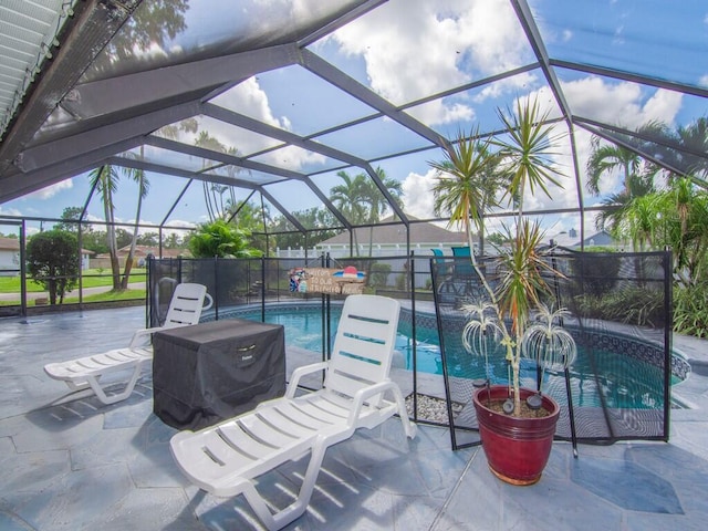 view of patio featuring glass enclosure and a fenced in pool