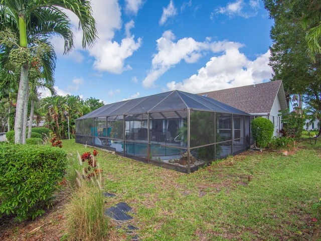 view of pool featuring a lanai and a yard