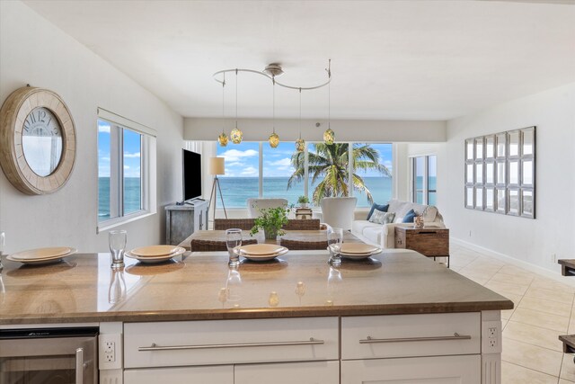 kitchen with a chandelier, white cabinets, beverage cooler, and decorative light fixtures