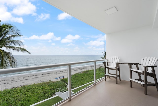 balcony featuring a water view and a view of the beach