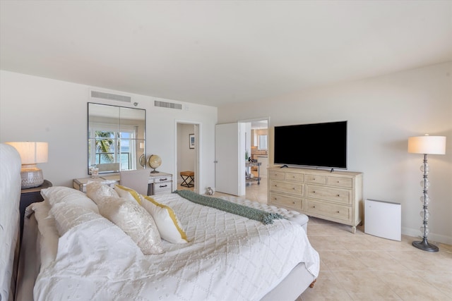 bedroom with light tile patterned flooring and a closet