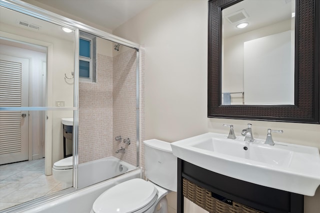 full bathroom with toilet, tile patterned floors, bath / shower combo with glass door, and vanity