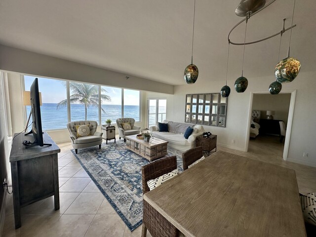 tiled bedroom with access to exterior and a water view