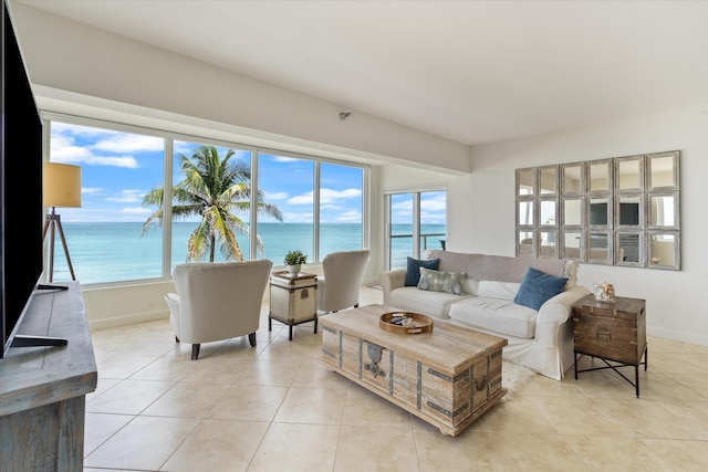 tiled living room featuring a water view