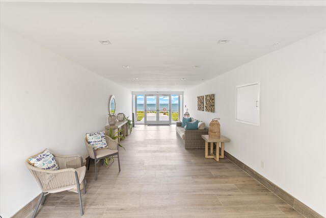 unfurnished room featuring light hardwood / wood-style floors and french doors