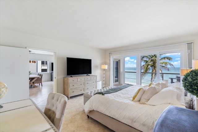 bedroom featuring multiple windows, access to outside, and light tile patterned floors