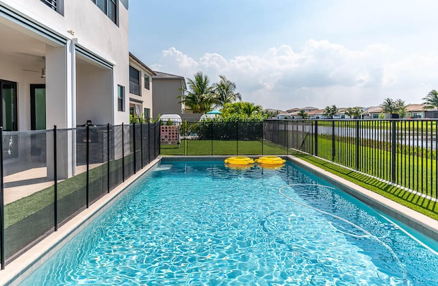 view of pool featuring a yard