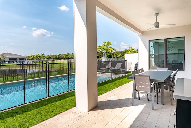 view of swimming pool with ceiling fan and a patio area