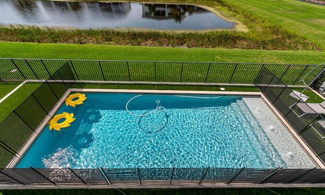 view of swimming pool featuring a water view and a yard