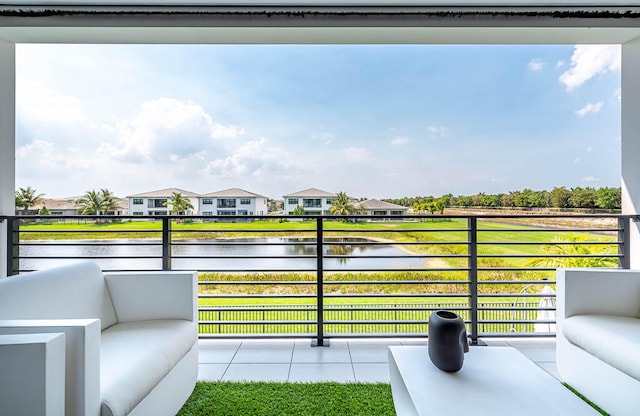 balcony featuring an outdoor hangout area and a water view