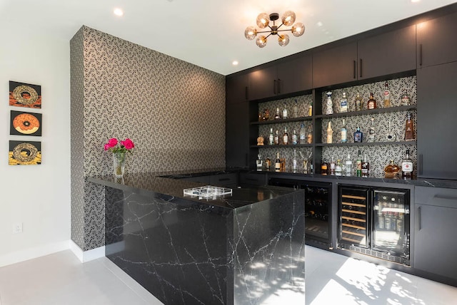 bar with wine cooler and dark stone counters