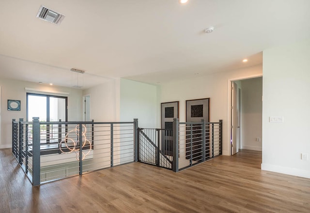 hallway with hardwood / wood-style floors