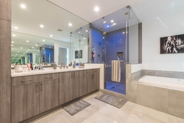 bathroom featuring tile patterned flooring, vanity, and independent shower and bath