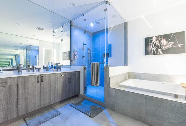 bathroom featuring tile patterned flooring, vanity, and shower with separate bathtub