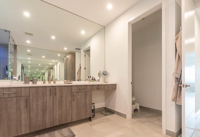 bathroom with tile patterned flooring, vanity, toilet, and an enclosed shower