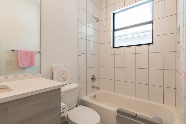 full bathroom featuring vanity, toilet, and tiled shower / bath