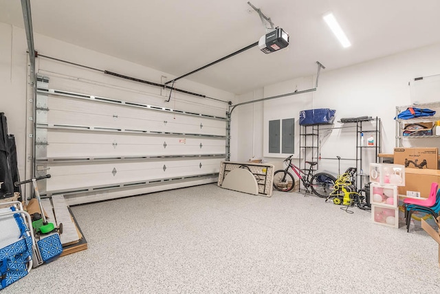 garage featuring electric panel and a garage door opener