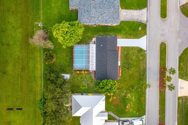 ranch-style home with a lawn, a garage, and central AC