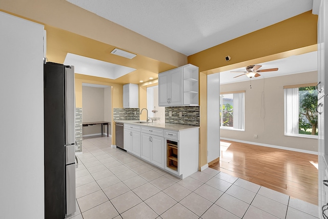 kitchen featuring light hardwood / wood-style floors, sink, white cabinetry, and stainless steel appliances