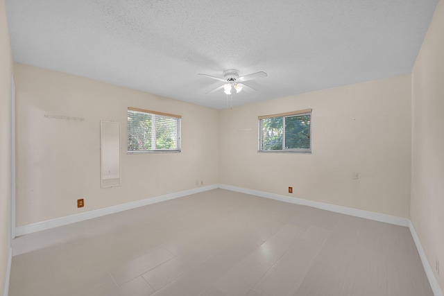 spare room featuring ceiling fan and a textured ceiling