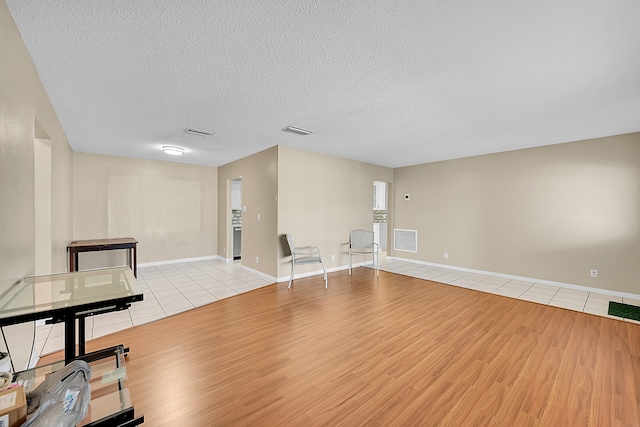 interior space featuring light hardwood / wood-style floors and a textured ceiling