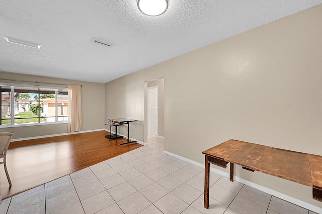 interior space featuring light hardwood / wood-style flooring and a textured ceiling