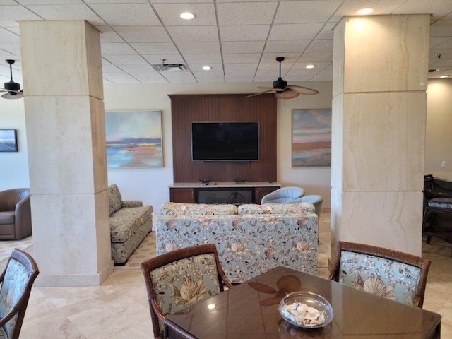 living room with a paneled ceiling and ceiling fan