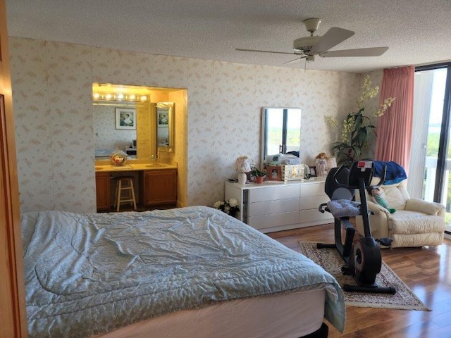 bedroom featuring wallpapered walls and multiple windows