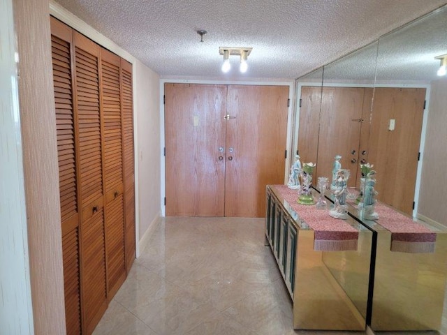 hallway with a textured ceiling