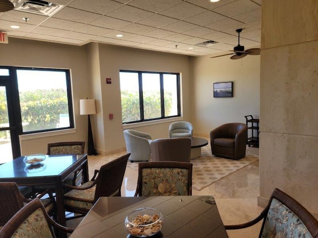 dining space with a ceiling fan, a paneled ceiling, and visible vents