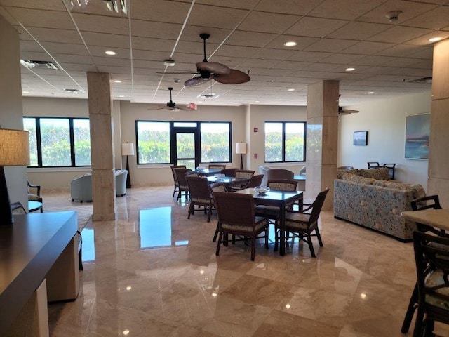 dining room with a drop ceiling, visible vents, marble finish floor, and ceiling fan