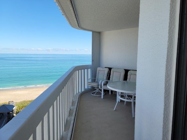 balcony with a beach view and a water view