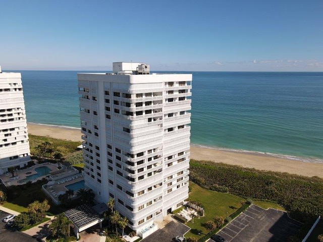 birds eye view of property with a view of the beach and a water view