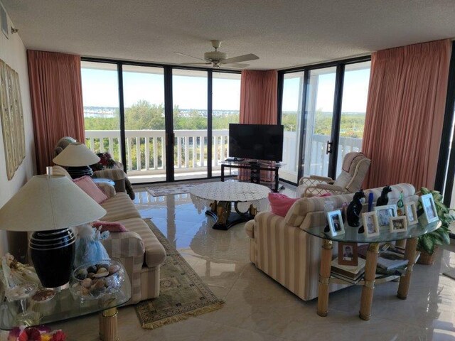 tiled dining area featuring a notable chandelier, a water view, a beach view, and a wealth of natural light