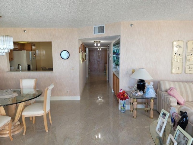 dining area with a textured ceiling