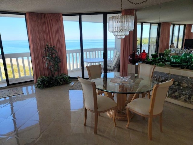 tiled dining area with an inviting chandelier, floor to ceiling windows, and a water view